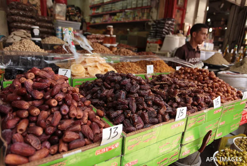 A Palestinian man sells dates in her shop at a market in Gaza City, as Muslims prepare for the upcoming holy fasting month of Ramadan, on June 28, 2014. on the eve of the start of the Muslim holy month of Ramadan. During...