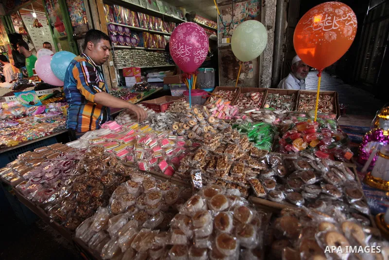 A Palestinian man sells sweets in her shop at a market in Gaza City, as Muslims prepare for the upcoming holy fasting month of Ramadan, on June 28, 2014. on the eve of the start of the Muslim holy month of Ramadan. Durin...