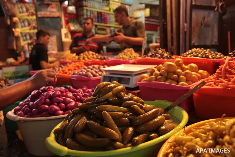 A Palestinian man sells pickles in her shop at a market in Gaza City, as Muslims prepare for the upcoming holy fasting month of Ramadan, on June 28, 2014. on the eve of the start of the Muslim holy month of Ramadan. Duri...