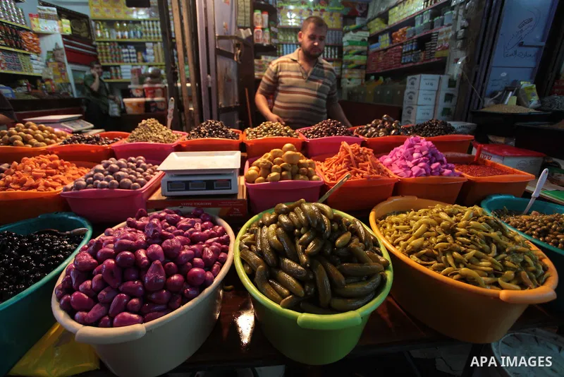 A Palestinian man sells pickles in her shop at a market in Gaza City, as Muslims prepare for the upcoming holy fasting month of Ramadan, on June 28, 2014. on the eve of the start of the Muslim holy month of Ramadan. Duri...