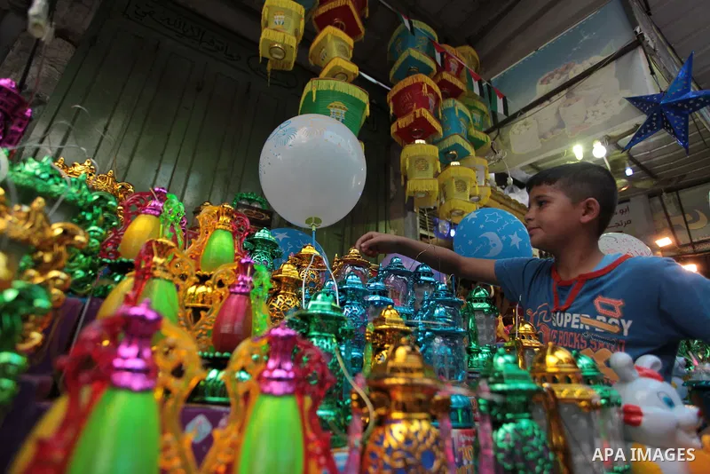 A Palestinian boy carries a traditional Ramadan lantern at a market in Gaza City, as Muslims prepare for the upcoming holy fasting month of Ramadan, on June 28, 2014. on the eve of the start of the Muslim holy month of R...