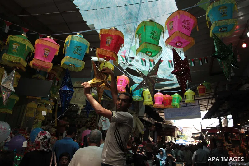 A Palestinian man sells a traditional Ramadan lantern in his shop at a market in Gaza City, as Muslims prepare for the upcoming holy fasting month of Ramadan, on June 28, 2014. on the eve of the start of the Muslim holy...