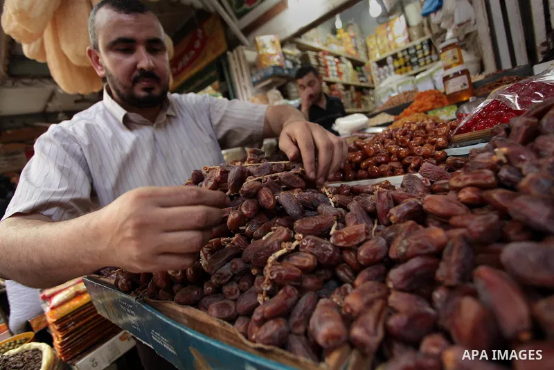 A Palestinian man sells dates in her shop at a market in Gaza City, as Muslims prepare for the upcoming holy fasting month of Ramadan, on June 28, 2014. on the eve of the start of the Muslim holy month of Ramadan. During...