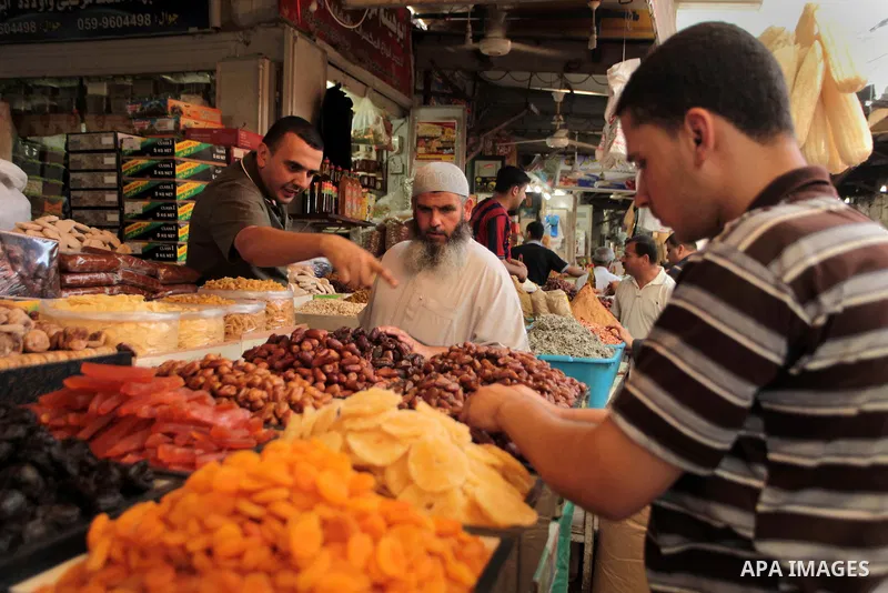 A Palestinian man sells spices in her shop at a market in Gaza City, as Muslims prepare for the upcoming holy fasting month of Ramadan, on June 28, 2014. on the eve of the start of the Muslim holy month of Ramadan. Durin...