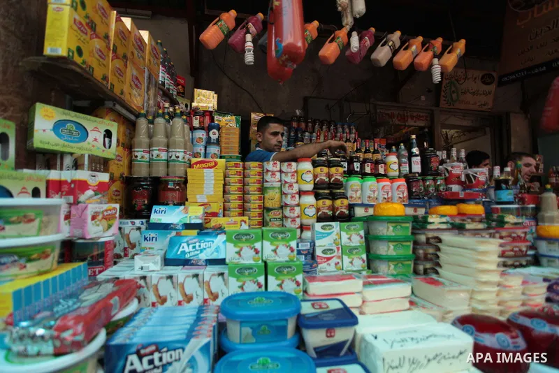A Palestinian man sells foods in her shop at a market in Gaza City, as Muslims prepare for the upcoming holy fasting month of Ramadan, on June 28, 2014. on the eve of the start of the Muslim holy month of Ramadan. During...