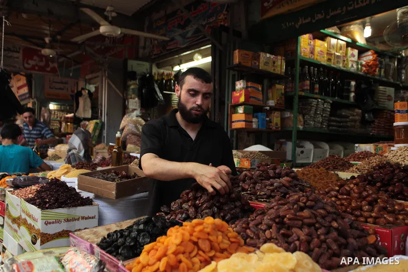 A Palestinian man sells dates in her shop at a market in Gaza City, as Muslims prepare for the upcoming holy fasting month of Ramadan, on June 28, 2014. on the eve of the start of the Muslim holy month of Ramadan. During...