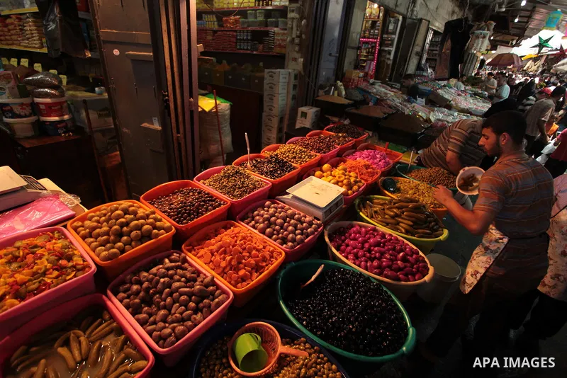 A Palestinian man sells pickles in her shop at a market in Gaza City, as Muslims prepare for the upcoming holy fasting month of Ramadan, on June 28, 2014. on the eve of the start of the Muslim holy month of Ramadan. Duri...
