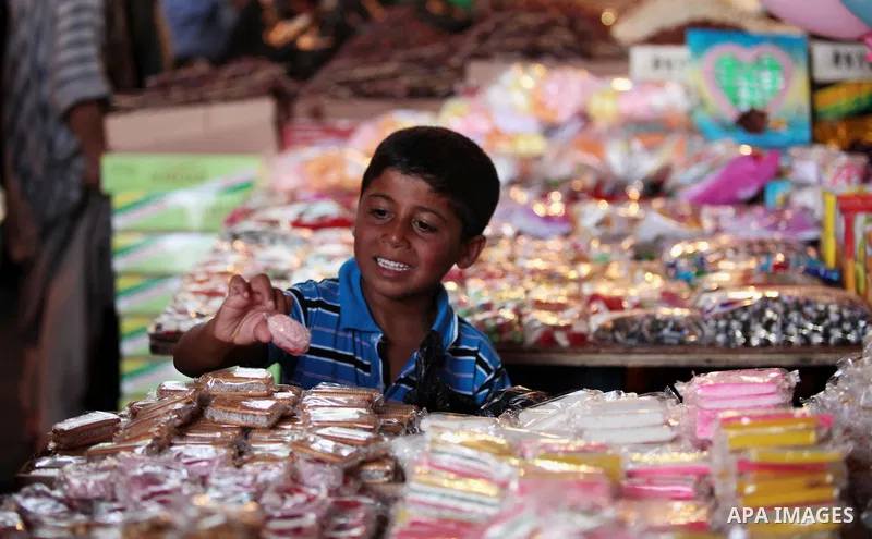 A Palestinian boy sells sweets in her shop at a market in Gaza City, as Muslims prepare for the upcoming holy fasting month of Ramadan, on June 28, 2014. on the eve of the start of the Muslim holy month of Ramadan. Durin...