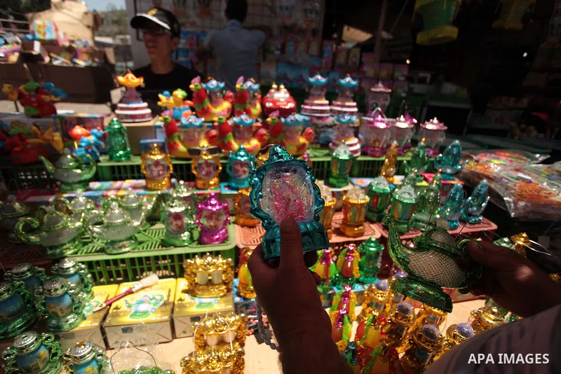 A Palestinian man sells a traditional Ramadan lantern in his shop at a market in Gaza City, as Muslims prepare for the upcoming holy fasting month of Ramadan, on June 28, 2014. on the eve of the start of the Muslim holy...