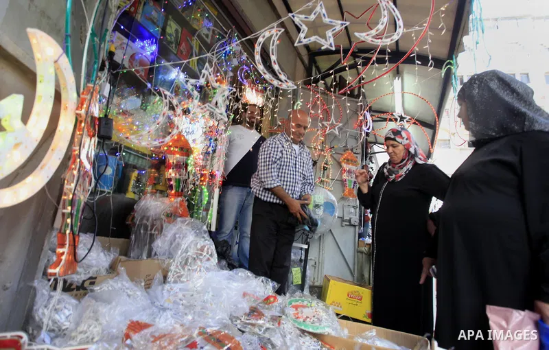 A Palestinian man sells decore lights in his shop at a market in the West Bank City of Ramallah, as Muslims prepare for the upcoming holy fasting month of Ramadan, on June 28, 2014. on the eve of the start of the Muslim...