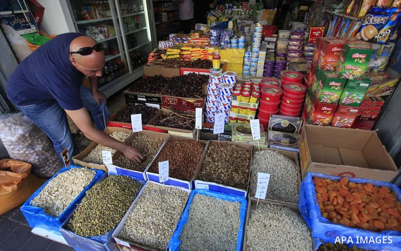 A Palestinian man sells nuts in his shop at a market in the West Bank City of Ramallah, as Muslims prepare for the upcoming holy fasting month of Ramadan, on June 28, 2014. on the eve of the start of the Muslim holy mont...