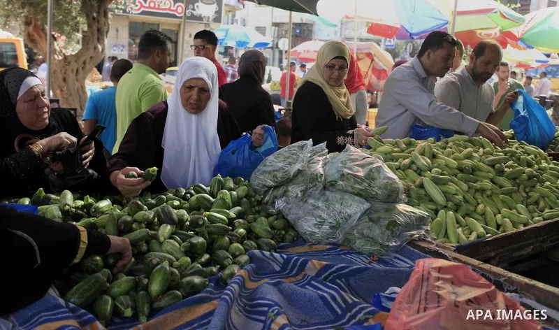 A Palestinian vendor sells vegetables in his shop at a market in the West Bank City of Ramallah, as Muslims prepare for the upcoming holy fasting month of Ramadan, on June 28, 2014. on the eve of the start of the Muslim...