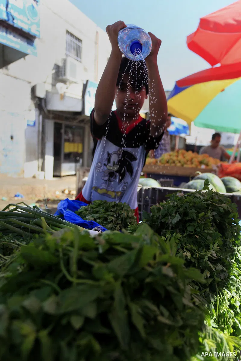 A Palestinian vendor sells vegetables in his shop at a market in the West Bank City of Ramallah, as Muslims prepare for the upcoming holy fasting month of Ramadan, on June 28, 2014. on the eve of the start of the Muslim...