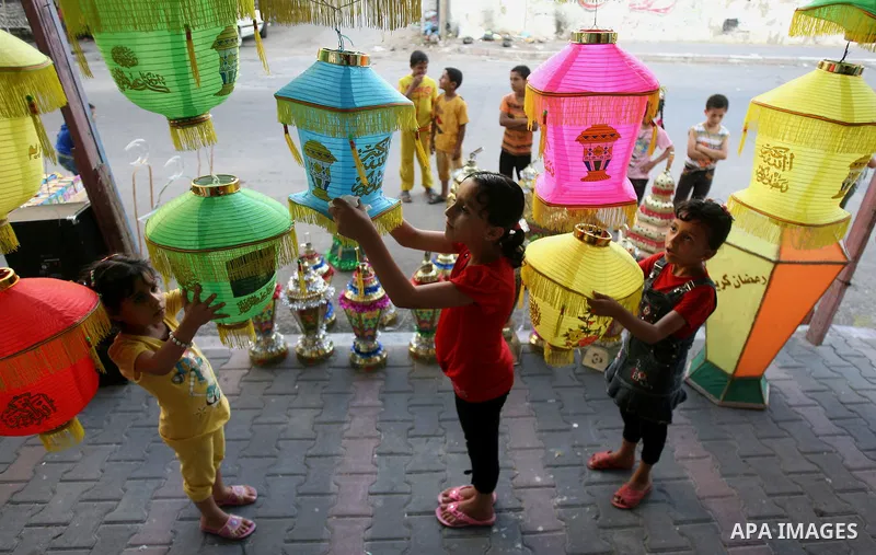 Palestinian children carry a traditional Ramadan lantern in Rafah in the southern of Gaza City, as Muslims prepare for the upcoming holy fasting month of Ramadan, on June 28, 2014. on the eve of the start of the Muslim h...