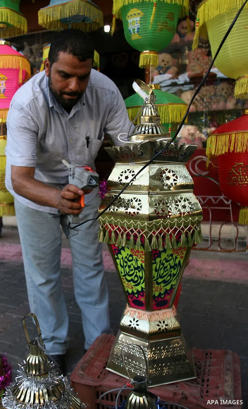 A Palestinian man sells a traditional Ramadan lantern in his shop at a market in Rafah in the southern of Gaza City, as Muslims prepare for the upcoming holy fasting month of Ramadan, on June 28, 2014. on the eve of the...