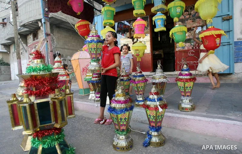 A Palestinian girl carries a traditional Ramadan lantern in Rafah in the southern of Gaza City, as Muslims prepare for the upcoming holy fasting month of Ramadan, on June 28, 2014. on the eve of the start of the Muslim h...