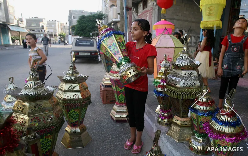 A Palestinian girl carries a traditional Ramadan lantern in Rafah in the southern of Gaza City, as Muslims prepare for the upcoming holy fasting month of Ramadan, on June 28, 2014. on the eve of the start of the Muslim h...