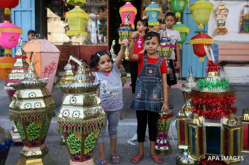 Palestinian children carry a traditional Ramadan lantern in Rafah in the southern of Gaza City, as Muslims prepare for the upcoming holy fasting month of Ramadan, on June 28, 2014. on the eve of the start of the Muslim h...