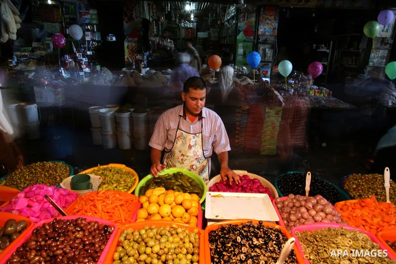 A Palestinian man sells pickles in her shop at a market in Gaza City, as Muslims prepare for the upcoming holy fasting month of Ramadan, on June 28, 2014. on the eve of the start of the Muslim holy month of Ramadan. Duri...