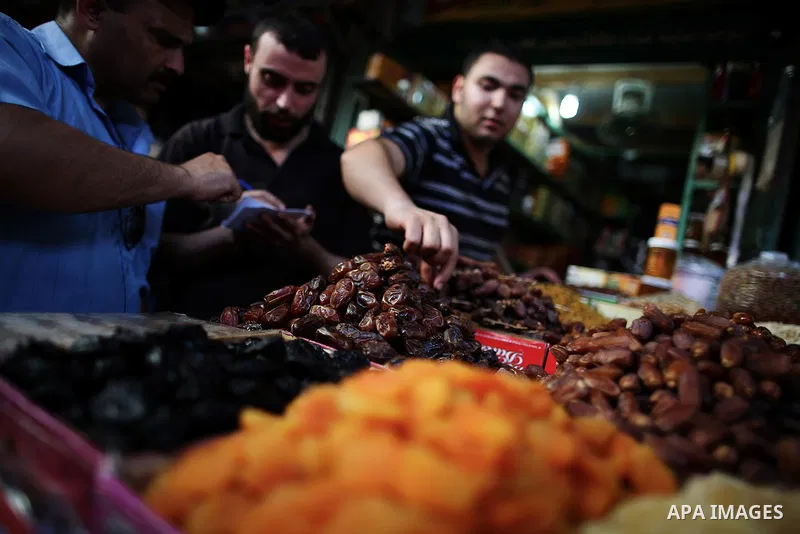 A Palestinian man sells dates in his shop at a market in Gaza City, as Muslims prepare for the upcoming holy fasting month of Ramadan, on June 28, 2014. on the eve of the start of the Muslim holy month of Ramadan. During...