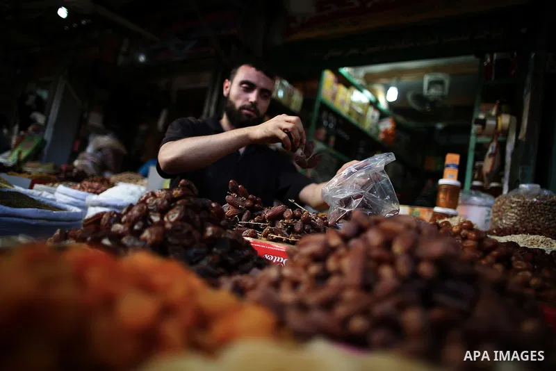 A Palestinian man sells dates in his shop at a market in Gaza City, as Muslims prepare for the upcoming holy fasting month of Ramadan, on June 28, 2014. on the eve of the start of the Muslim holy month of Ramadan. During...