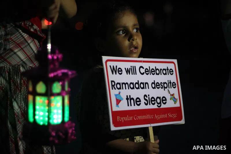 Palestinians children hold Ramadan lanterns during a night vigil in Gaza City, calling for international attention to the deteriorating economic situation in the territory. Saturday, June 28, 2014. Ramadan falls this yea...