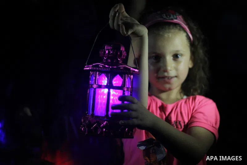 Palestinians children hold Ramadan lanterns during a night vigil in Gaza City, calling for international attention to the deteriorating economic situation in the territory. Saturday, June 28, 2014. Ramadan falls this yea...