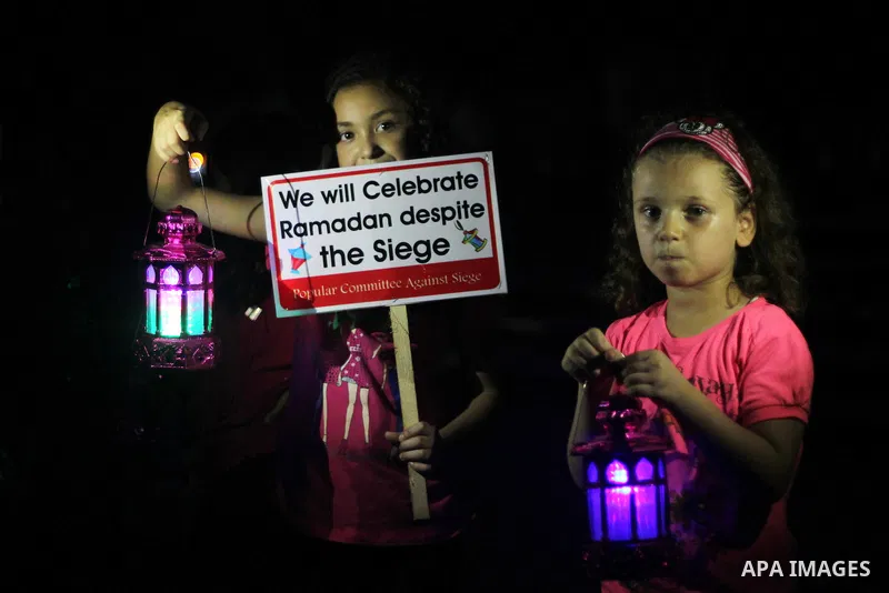 Palestinians children hold Ramadan lanterns during a night vigil in Gaza City, calling for international attention to the deteriorating economic situation in the territory. Saturday, June 28, 2014. Ramadan falls this yea...