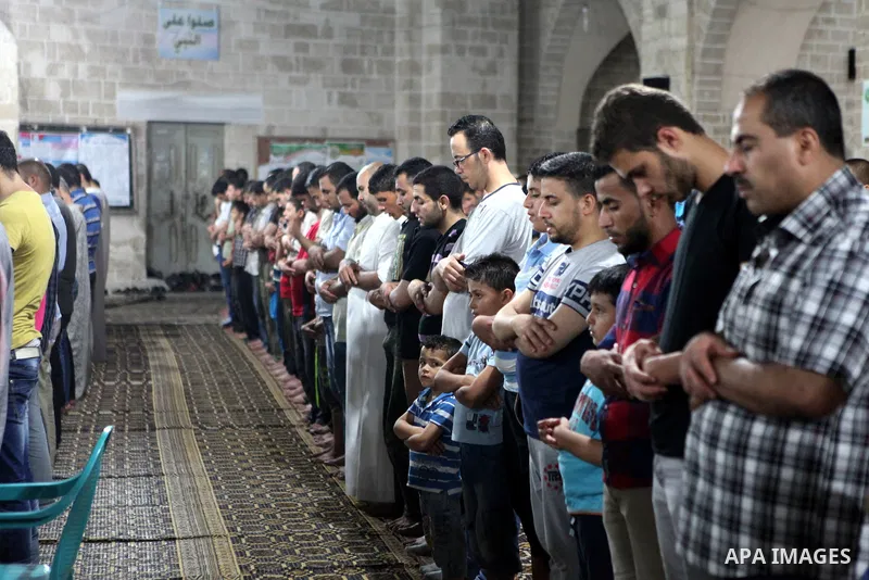 Palestinian Muslims pray al-Taraweeh prayer at al-Omari Mosque in Gaza city on June 28, 2014. Muslim believers abstain from eating, drinking, smoking and having sex from dawn until sunset. Ramadan is sacred to Muslims be...