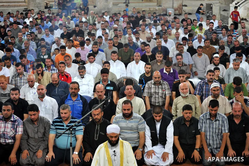 Palestinian Muslims pray al-Taraweeh prayer at al-Omari Mosque in Gaza city on June 28, 2014. Muslim believers abstain from eating, drinking, smoking and having sex from dawn until sunset. Ramadan is sacred to Muslims be...