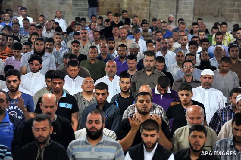 Palestinian Muslims pray al-Taraweeh prayer at al-Omari Mosque in Gaza city on June 28, 2014. Muslim believers abstain from eating, drinking, smoking and having sex from dawn until sunset. Ramadan is sacred to Muslims be...