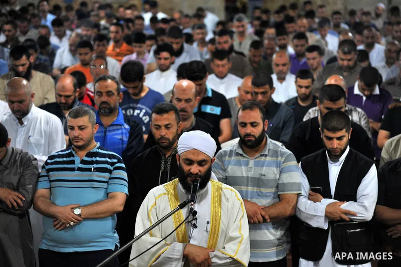 Palestinian Muslims pray al-Taraweeh prayer at al-Omari Mosque in Gaza city on June 28, 2014. Muslim believers abstain from eating, drinking, smoking and having sex from dawn until sunset. Ramadan is sacred to Muslims be...