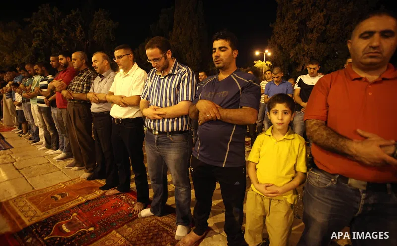 Palestinian Muslims pray al-Taraweeh prayer in front of the Dome of the Rock at the Al-Aqsa mosque compound in the old city of Jerusalem on June 28, 2014. Muslim believers abstain from eating, drinking, smoking and havin...