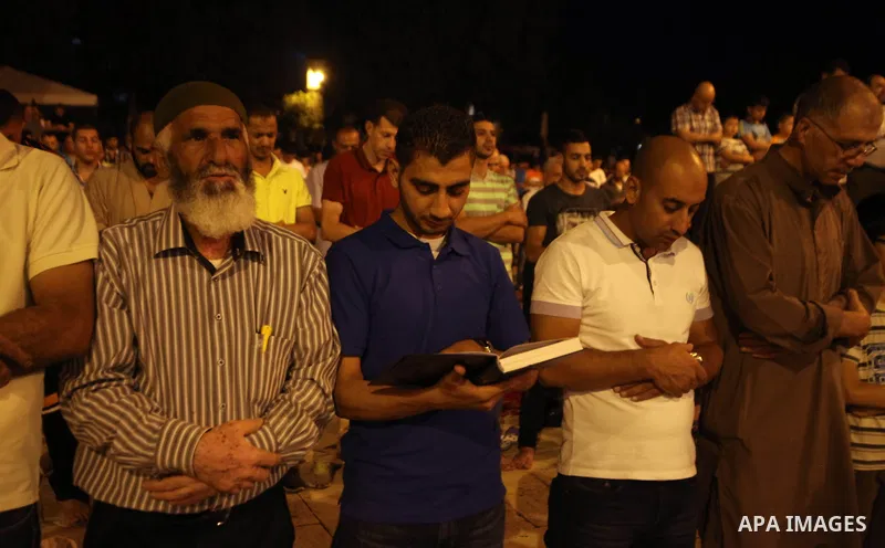 Palestinian Muslims pray al-Taraweeh prayer in front of the Dome of the Rock at the Al-Aqsa mosque compound in the old city of Jerusalem on June 28, 2014. Muslim believers abstain from eating, drinking, smoking and havin...