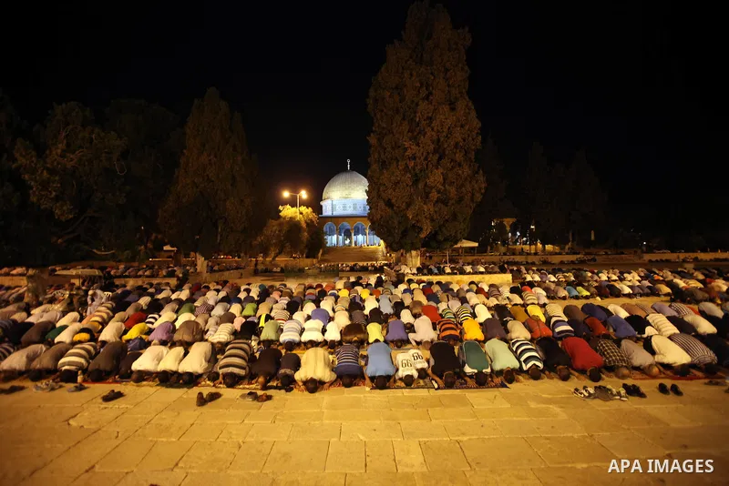 Palestinian Muslims pray al-Taraweeh prayer in front of the Dome of the Rock at the Al-Aqsa mosque compound in the old city of Jerusalem on June 28, 2014. Muslim believers abstain from eating, drinking, smoking and havin...
