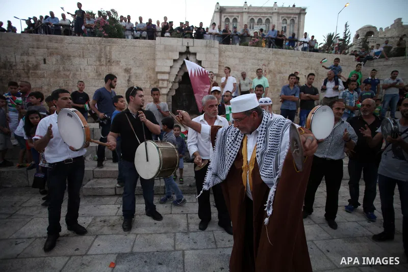 Palestinian musicians perform in Jerusalem's Old City during celebrations in preparation for the Muslim holy month of Ramadan, June 28, 2014. on the eve of the start of the Muslim holy month of Ramadan. During Ramadan, M...