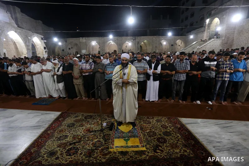 Palestinian Muslims pray al-Taraweeh prayer at al-Omari Mosque in Gaza city on June 28, 2014. Muslim believers abstain from eating, drinking, smoking and having sex from dawn until sunset. Ramadan is sacred to Muslims be...