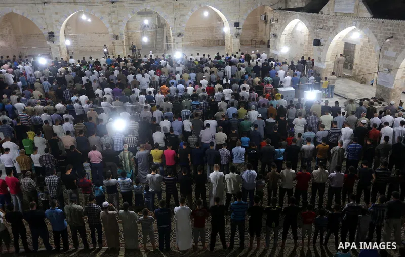 Palestinian Muslims pray al-Taraweeh prayer at al-Omari Mosque in Gaza city on June 28, 2014. Muslim believers abstain from eating, drinking, smoking and having sex from dawn until sunset. Ramadan is sacred to Muslims be...