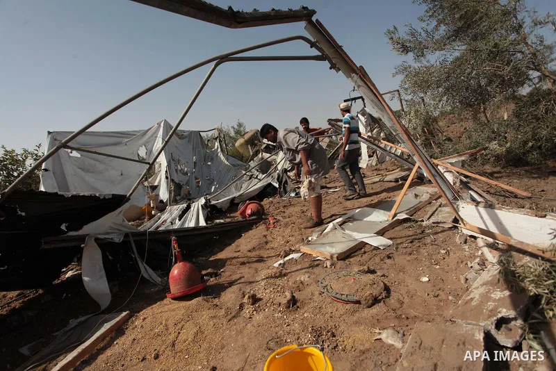 Palestinian men inspect a chicken coop damaged in an Israeli air strike in Bureij refugee camp in central Gaza Strip, on June 29, 2014. Israeli warplanes launched a series of air strikes across the Gaza Strip early Sunda...