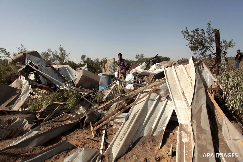 Palestinian men inspect a chicken coop damaged in an Israeli air strike in Bureij refugee camp in central Gaza Strip, on June 29, 2014. Israeli warplanes launched a series of air strikes across the Gaza Strip early Sunda...