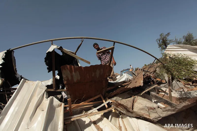 A Palestinian man inspects a chicken coop damaged in an Israeli air strike in Bureij refugee camp in central Gaza Strip, on June 29, 2014. Israeli warplanes launched a series of air strikes across the Gaza Strip early Su...