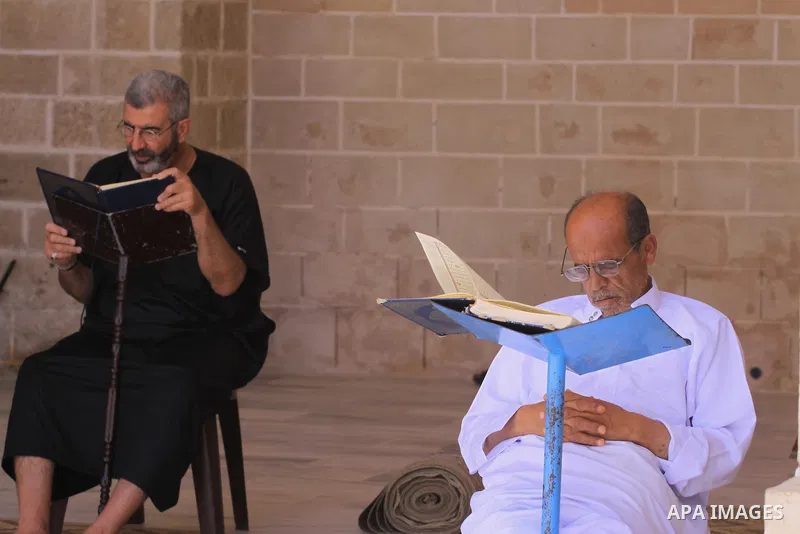 Palestinian muslims read the holy Qur'an at al-Omari mosque in Gaza city, on June 29, 2014. Muslims around the world refrain from eating, drinking and sexual intercourse from dawn till dusk during Ramadan, the holiest mo...