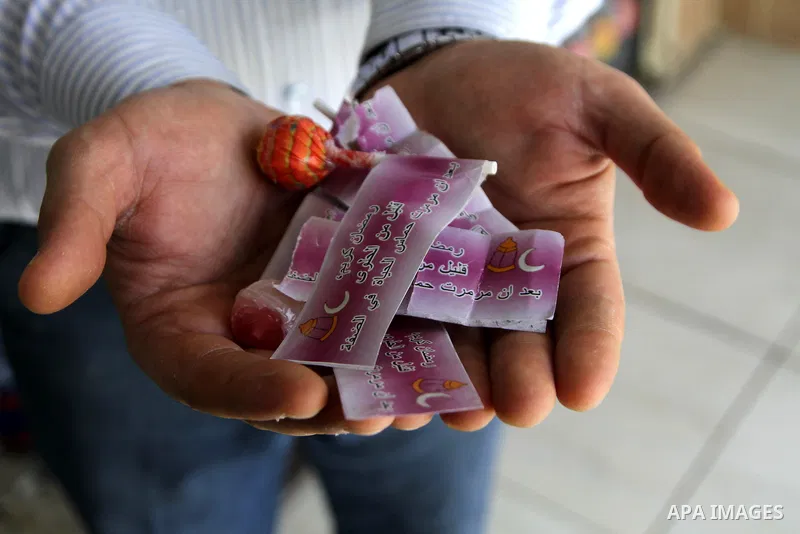 A Palestinian man carries sweets distributed by the Israeli army write "Ramadan Kareem few of the candy after Hamas makes the life badly in the Bank", which calls to incitement against Hamas, in the Balata refugee camp n...