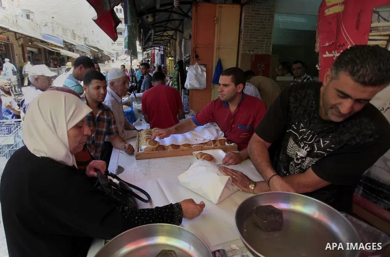 A Palestinian sweet maker prepares pancake called "katayef" on the First day of Ramadan, the holy fasting month, in the West Bank city of Ramallah on June 29, 2014. Muslim believers abstain from eating, drinking, smoking...