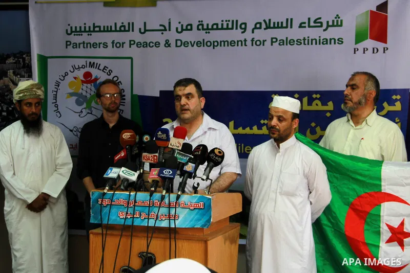 Members of the aid convoy of "Miles of Smiles 28" hold a press conference upon their arrival at the Rafah crossing border, in the southern Gaza Strip, June 29, 2014. Photo by Eyad Al Baba