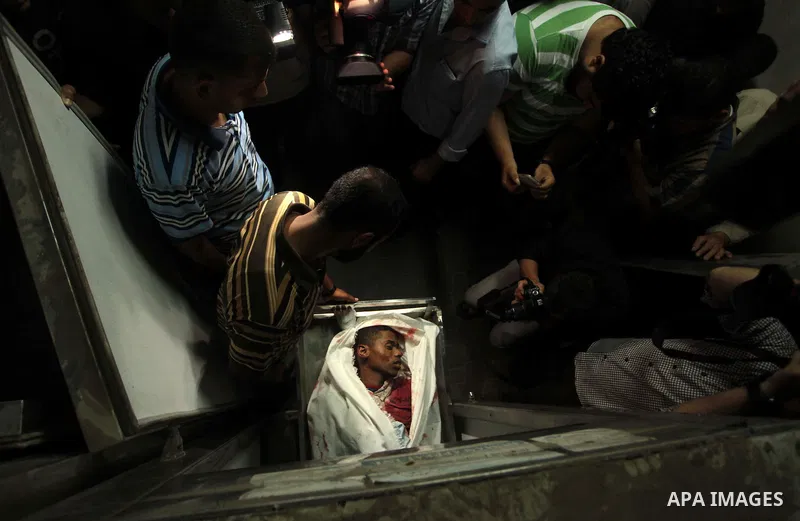 Palestinian relatives mourn the death of a Hamas gunman at a hospital morgue in Khan Younis in the southern Gaza Strip June 29, 2014. Israeli forces attacked militant targets in the Gaza Strip on Sunday, killing a Hamas...