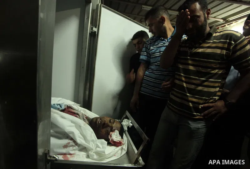 Palestinian relatives mourn the death of a Hamas gunman at a hospital morgue in Khan Younis in the southern Gaza Strip June 29, 2014. Israeli forces attacked militant targets in the Gaza Strip on Sunday, killing a Hamas...