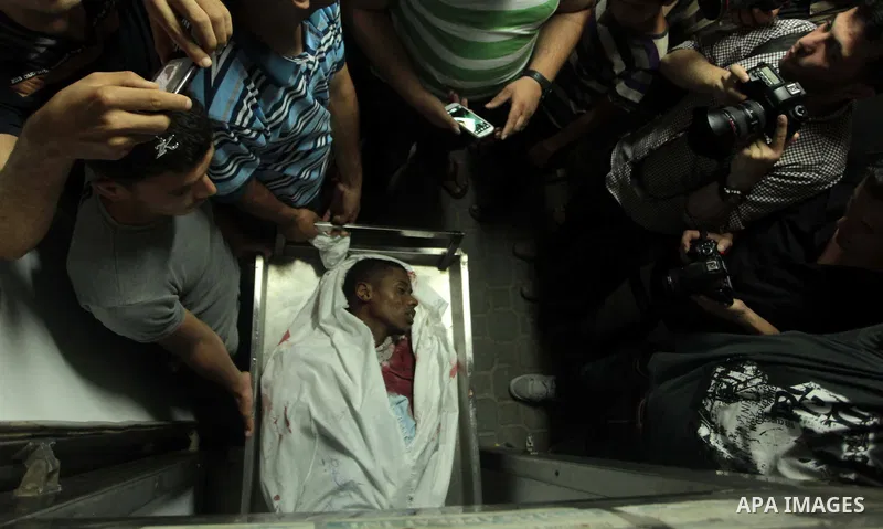 Palestinian relatives mourn the death of a Hamas gunman at a hospital morgue in Khan Younis in the southern Gaza Strip June 29, 2014. Israeli forces attacked militant targets in the Gaza Strip on Sunday, killing a Hamas...