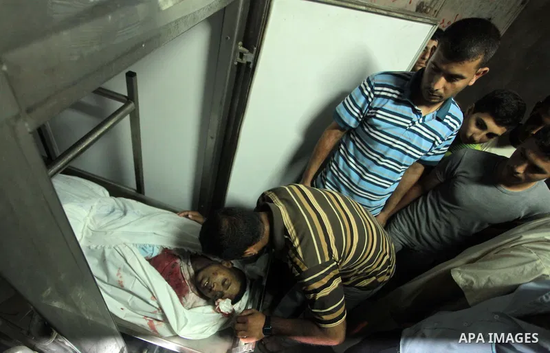 Palestinian relatives mourn the death of a Hamas gunman at a hospital morgue in Khan Younis in the southern Gaza Strip June 29, 2014. Israeli forces attacked militant targets in the Gaza Strip on Sunday, killing a Hamas...