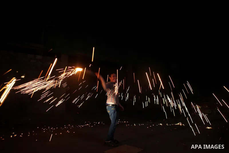 A Palestinian boy plays with fire crackers celebrating ahead of the Muslim holy month of Ramadan, in Gaza city on June 29, 2014. Muslims around the world refrain from eating, drinking and sexual intercourse from dawn til...